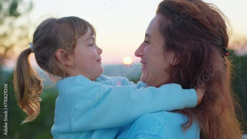 Happy cute affectionate adopted little kid girl hugging foster care parent mother with eyes closed, adorable small child daughter embrace mum cuddling enjoy tender sweet moment concept, close up view photo
