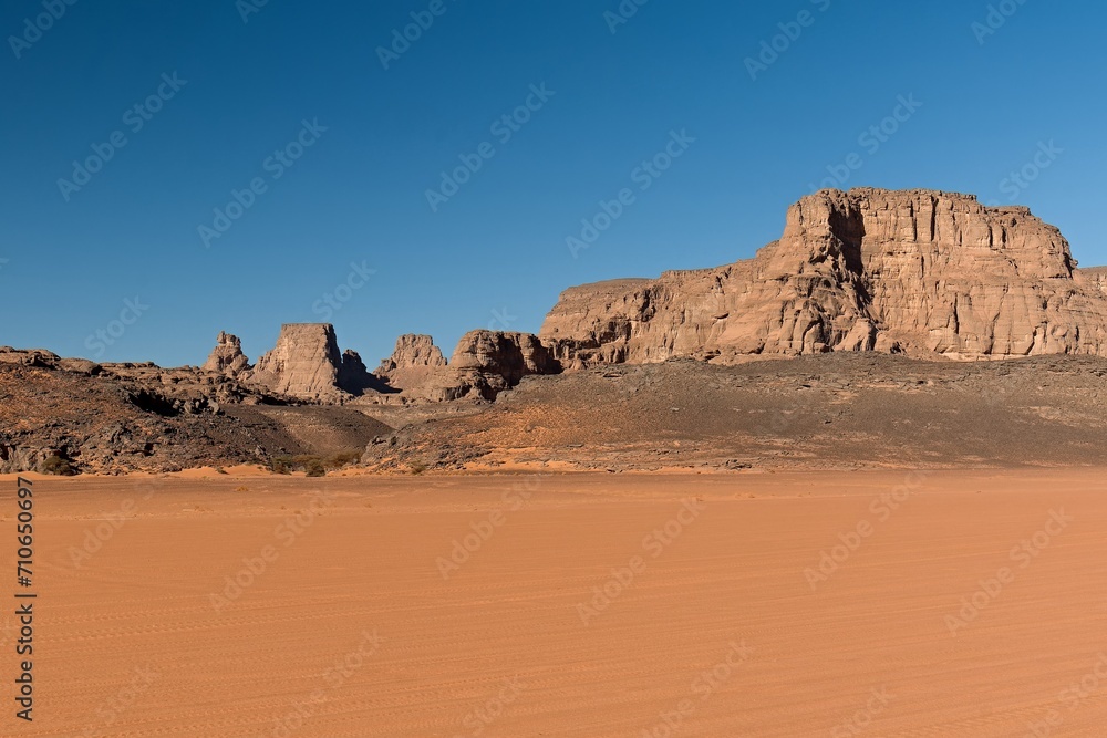 View of the Tadrart Rouge rocky mountain range in Tassili n Ajjer National Park. Sahara desert, Algeria, Africa. View of the Tadrart Rouge rocky mountain range in Tassili n Ajjer National Park. Sahara desert, Algeria, Africa.