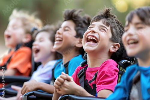 portrait of children in wheelchairs, laughing and talking happily © Kien