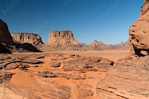 View of Tamezguida rock formation in Tadrart Rouge rocky mountain range in Tassili n Ajjer National Park. Sahara desert, Algeria, Africa. photo
