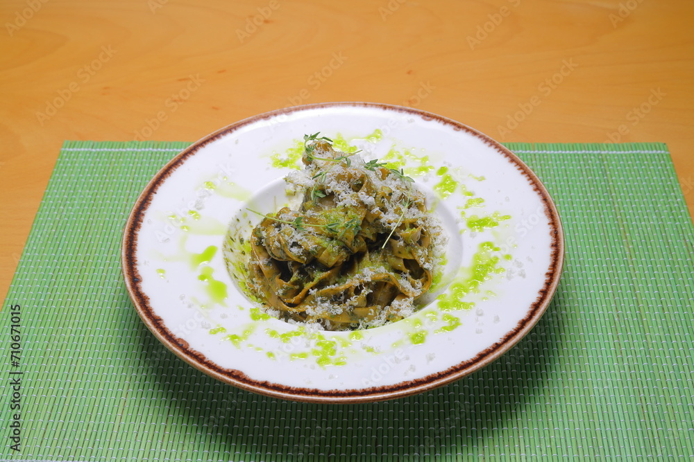 Italian tortellini pasta in cream sauce.with spinach. White wooden background. Top view Italian tortellini pasta in cream sauce.with spinach. White wooden background. Top view