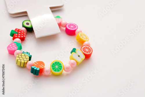 Bracelet with tag and fruit-shaped beads