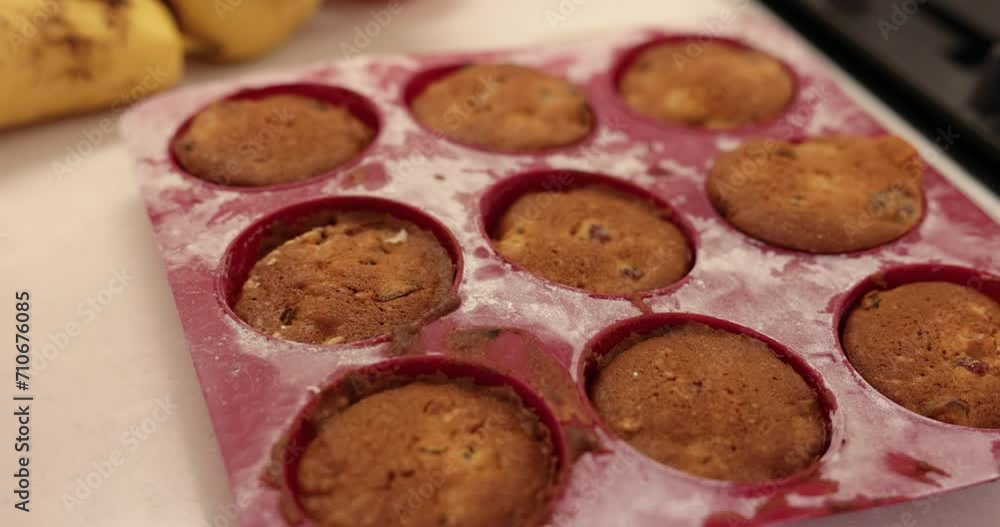 fresh tasty muffins in baking forms on table at home fresh tasty muffins in baking forms on table at home