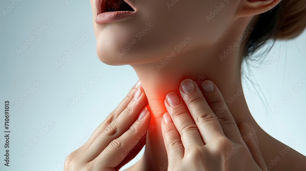 Woman holding on to sore throat, lesion in tonsils, throat disease