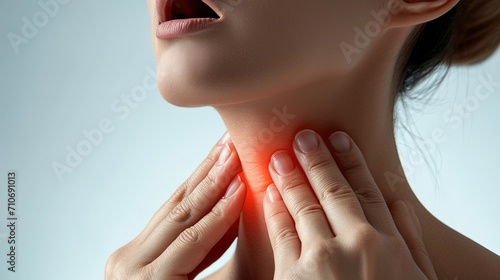 Woman holding on to sore throat, lesion in tonsils, throat disease, acute respiratory viral infection, tracheitis, season of viral activity photo