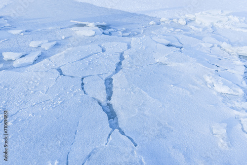 Ice hummocks covered with snow. Broken ice fragments