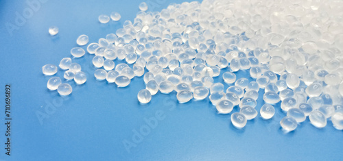 virgin polymer material granules isolated on a blue background for industrial plastic product catalog design