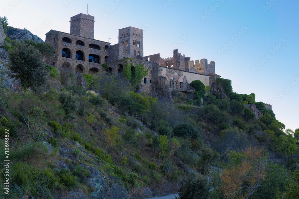 The Monastery of Sant Pere de Rodes stands imposingly on the Alt Empordà mountain, a testament to Catalan Romanesque architecture surrounded by robust nature.