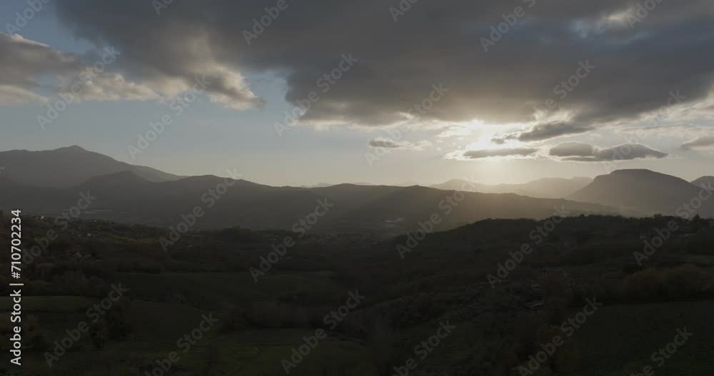 Aerial view of the valley with countryside and mountain landscape at sunset near Nusco in Irpinia, Avellino, Campania, Italy. Aerial view of the valley with countryside and mountain landscape at sunset near Nusco in Irpinia, Avellino, Campania, Italy.