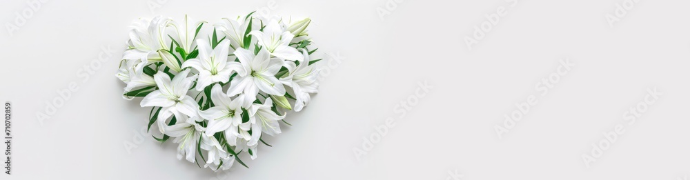 Fototapeta premium wedding or memorial bouquet of white lilies. heart shaped flower arrangement. horizontal wallpaper with large copy space for text. Condolence, grieving card, loss, funerals, support