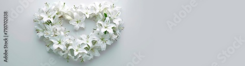 memorial bouquet of white lilies. heart shaped flower arrangement. horizontal wallpaper with large copy space for text. Condolence, grieving card, loss, funerals, support