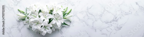 memorial bouquet of white lilies. heart shaped flower arrangement. on white marble horizontal wallpaper with large copy space for text. Condolence, wedding , loss, funerals, support