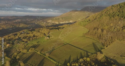 Aerial view of a mountains and hills landscape with vineyard and countryside houses at sunset in autumn colours, Irpinia, Avellino, Campania, Italy.