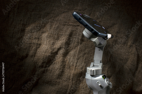 Close-up of steadicam with phone for video or live broadcast. Indoor studio shot isolated on background. photo