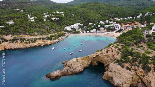 Aerial view of sailing boats moored in a small bay with cliffs and coves facing the Mediterranean Sea, Cala Vedella, Sant Josep de Sa Talaia, Balearic Islands, Spain. photo