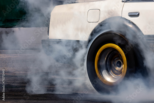 Car burnout wheels tire with white smoke,Car wheel burnout with smoke from the spinning tyre, Drag car wheel burns tires preparation for the race.
