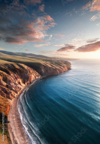 Aerial view of the Fleurieu Peninsula Sellicks Beach coastline from high above the beach with soft sunset clouds in the background. Fleurieu Peninsula, South Australia, Australia. photo