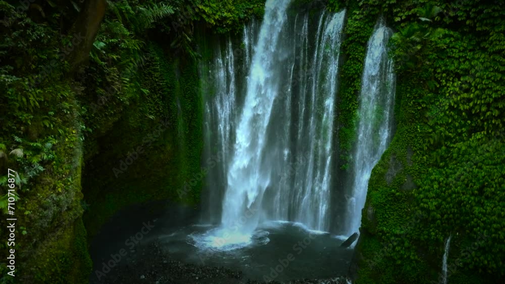 Aerial view of a person at Tiu Kelep Waterfall, Lombok, Bali, Indonesia. Aerial view of a person at Tiu Kelep Waterfall, Lombok, Bali, Indonesia.