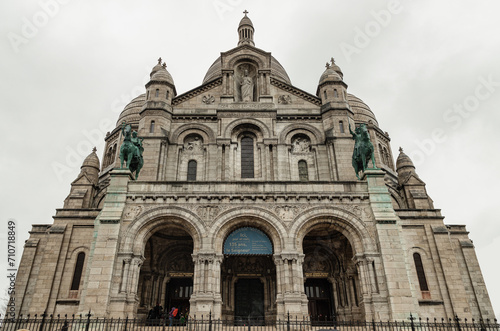 The Roman Catholic church Sacr-Coeur Basilica in Montmartre with the bronze statues of Joan of Arc and Louis IX on either side, Romano-Byzantine architecture constructed in travertine. Space for text,
