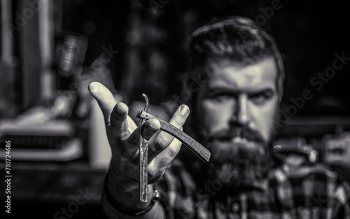 Straight razor, barbershop, beard. Portrait of brutal bearded man. Vintage straight razor. Black and white