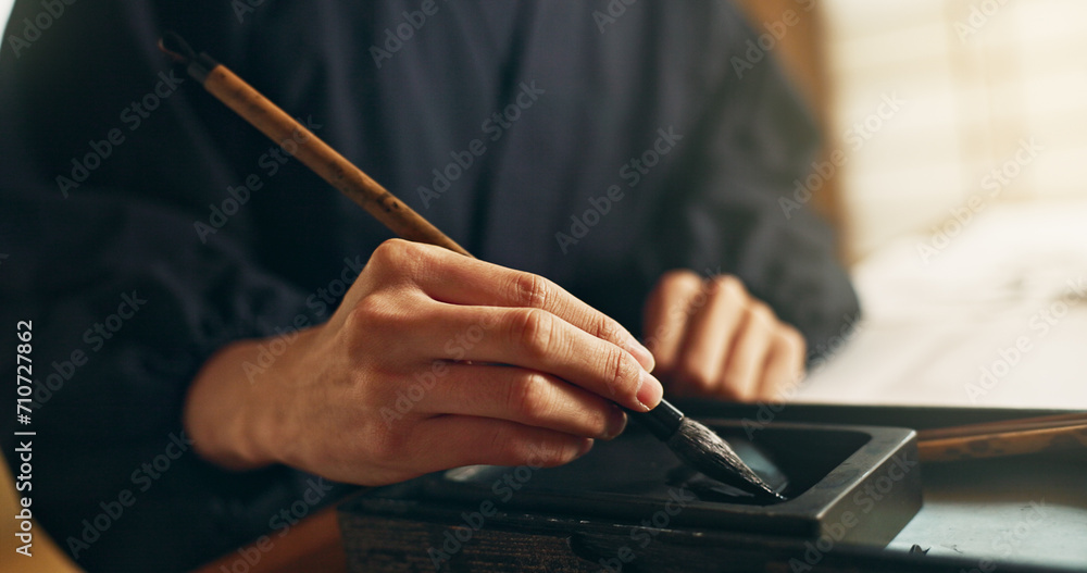 Hands, reed pen or brush in ink for writing, calligraphy or ancient script for art and inkstone. Japanese creativity, black paint and vintage tools, paintbrush and stroke, traditional and stationery - obrazy, fototapety, plakaty 