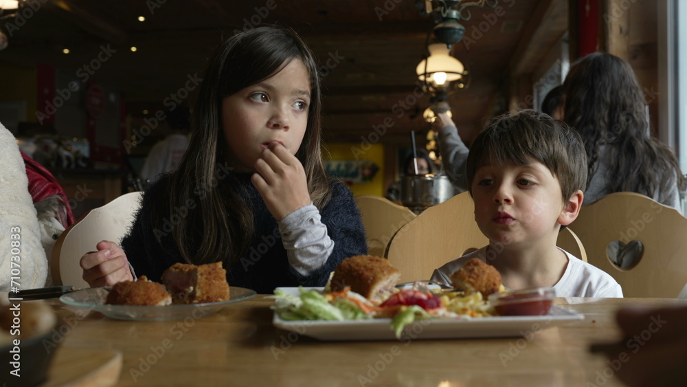 Cozy Diner Experience - Siblings Sharing Meal at Family-Friendly Restaurant