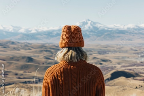 Contemplative Gaze Over Mountain Range. Individual in contemplation looking out over a vast mountain range, a moment of solitude and reflection.