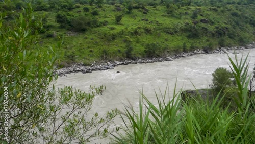 Sutlej or Satluj River flowing through the valleys of Himachal Pradesh. Monsoon season in India. photo