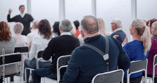 Audience of adult people listen to the speech of the lecturer