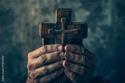 close up person holding bible while praying