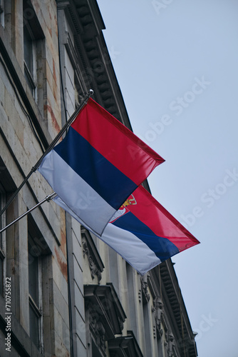 Two Serbian national flags waving on the building in historical center of Belgrade  Serbia.