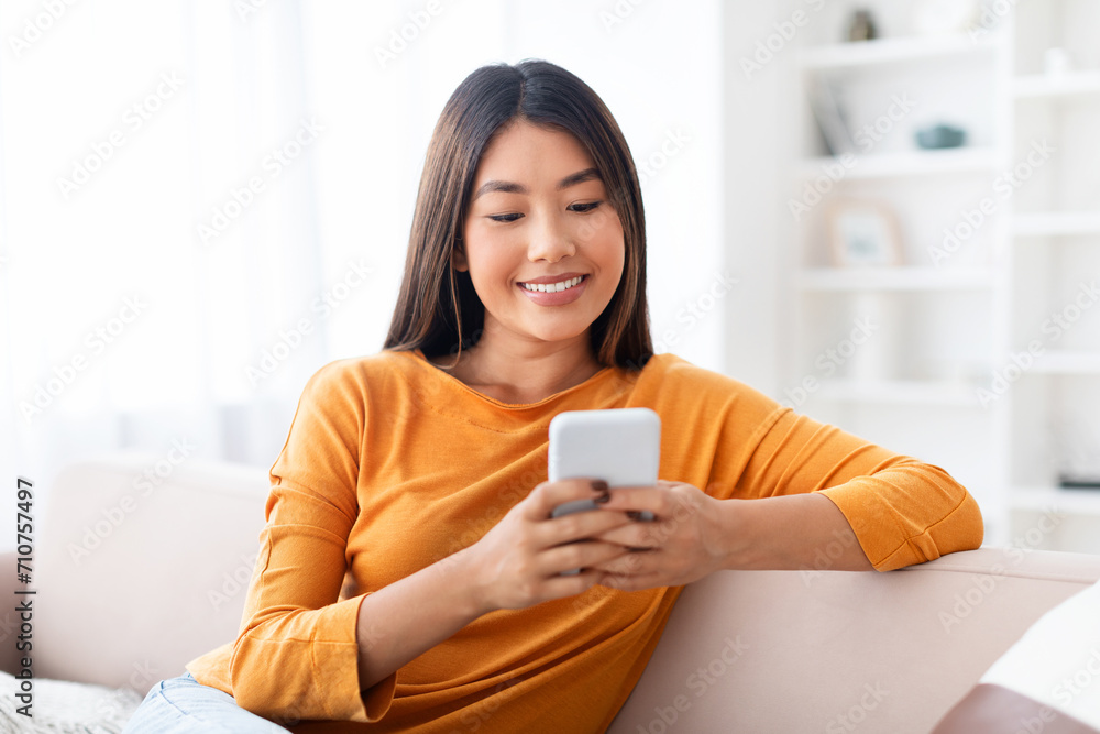 Closeup candid photo of young pretty asian lady using smartphone Closeup candid photo of young pretty asian lady using smartphone