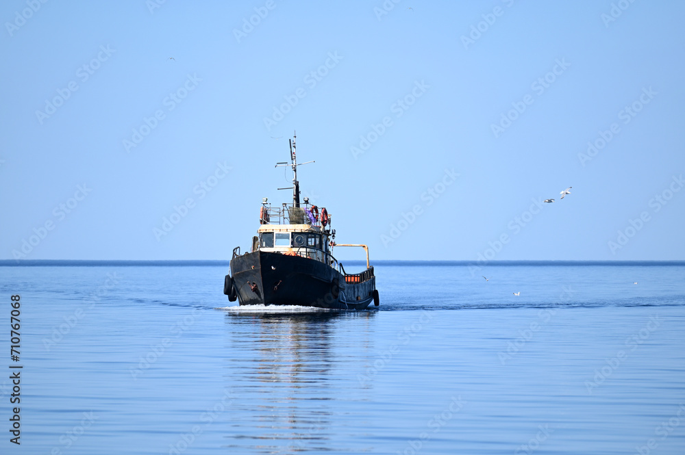 Small fishing boat sailing in sea Small fishing boat sailing in sea