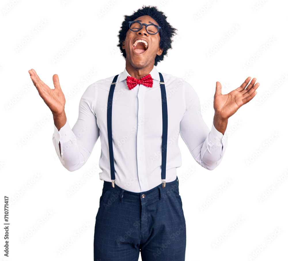 Handsome african american man with afro hair wearing hipster elegant look celebrating mad and crazy for success with arms raised and closed eyes screaming excited. winner concept Handsome african american man with afro hair wearing hipster elegant look celebrating mad and crazy for success with arms raised and closed eyes screaming excited. winner concept