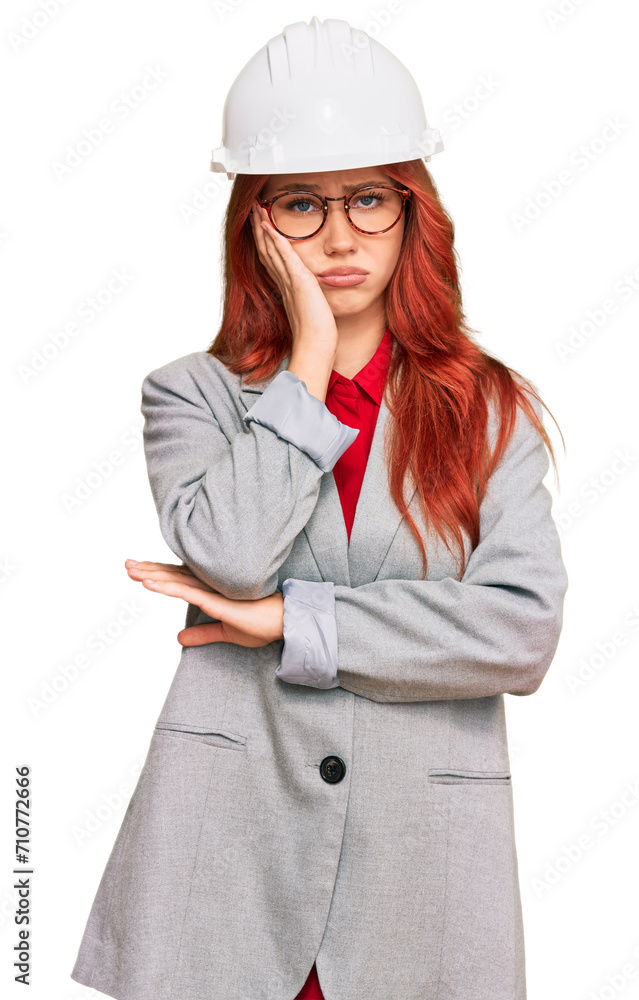 Young redhead woman wearing architect hardhat thinking looking tired and bored with depression problems with crossed arms. Young redhead woman wearing architect hardhat thinking looking tired and bored with depression problems with crossed arms.