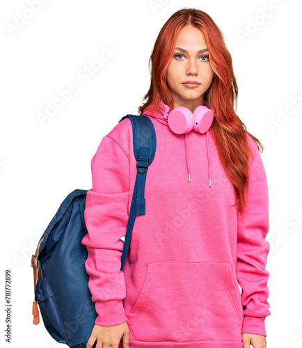 Foto Young redhead woman holding student backpack and books thinking attitude and sob