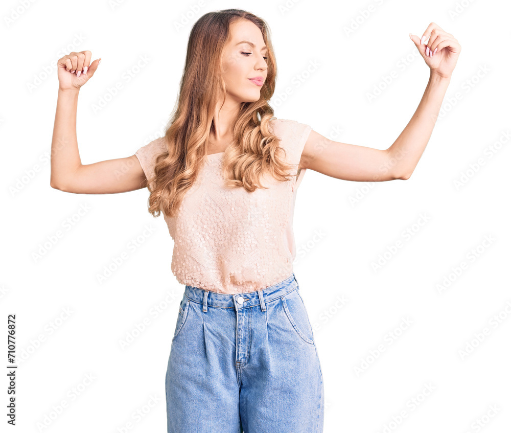 Young beautiful caucasian woman with blond hair wearing casual clothes showing arms muscles smiling proud. fitness concept. Young beautiful caucasian woman with blond hair wearing casual clothes showing arms muscles smiling proud. fitness concept.