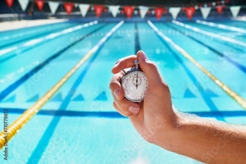 Hand, stopwatch and swimming pool for sport, training and workout with preparation for competition. Person, coach or mentor with clock, timer or watch for speed, progress and tracking lap for race