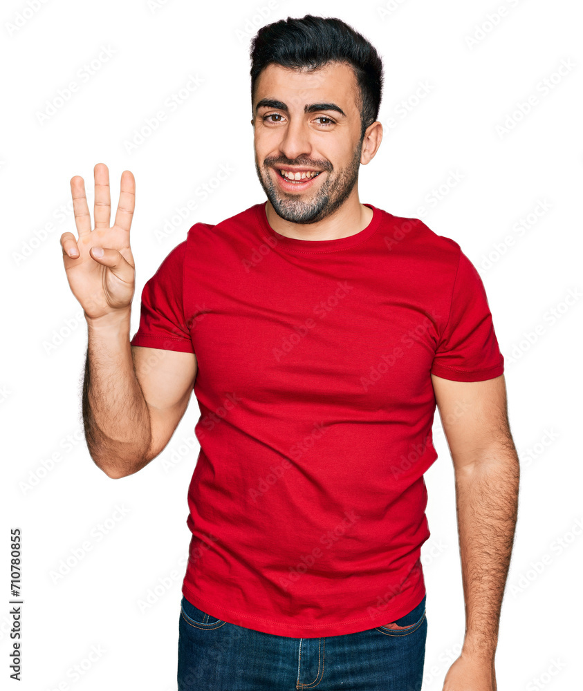 Hispanic man with beard wearing casual red t shirt showing and pointing up with fingers number three while smiling confident and happy. Hispanic man with beard wearing casual red t shirt showing and pointing up with fingers number three while smiling confident and happy.