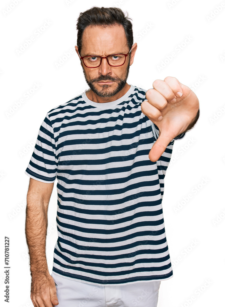 Middle age man wearing casual clothes and glasses looking unhappy and angry showing rejection and negative with thumbs down gesture. bad expression. Middle age man wearing casual clothes and glasses looking unhappy and angry showing rejection and negative with thumbs down gesture. bad expression.