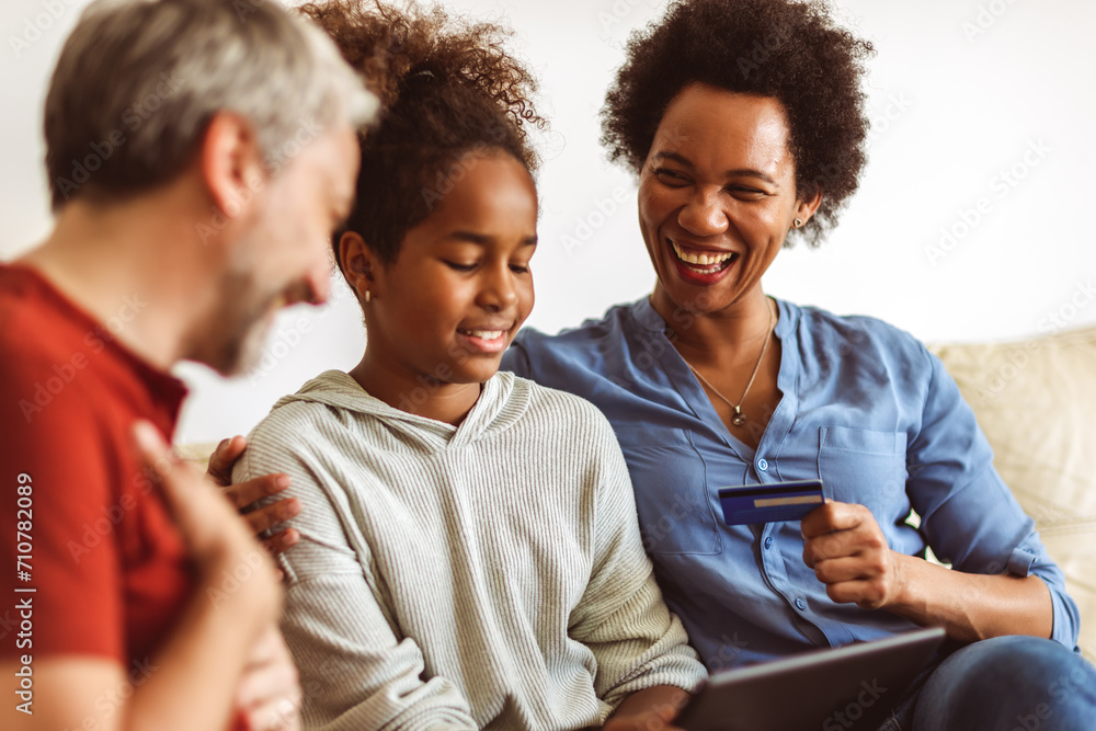 Family Using Digital Tablet And Credit Card At Home Family Using Digital Tablet And Credit Card At Home