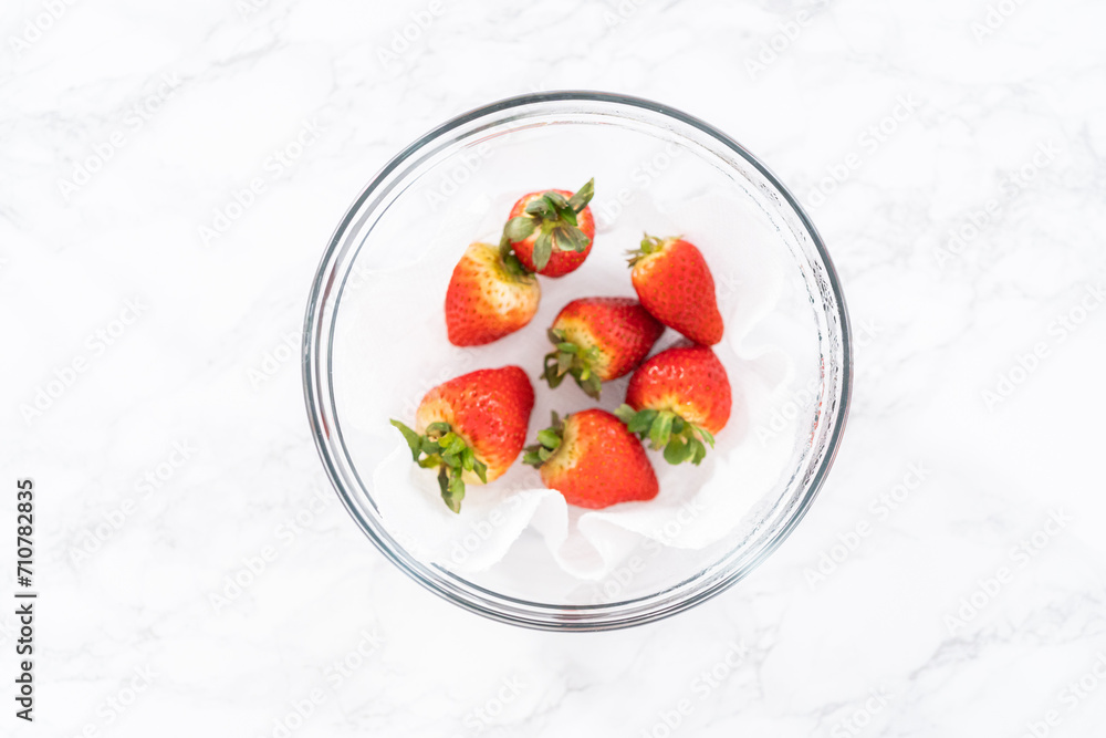 Washed and Dried Strawberries Neatly Stored in a Glass Bowl Washed and Dried Strawberries Neatly Stored in a Glass Bowl