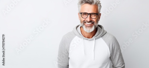 Confident senior man smiling casually against grey background. Modern retirement lifestyle. photo