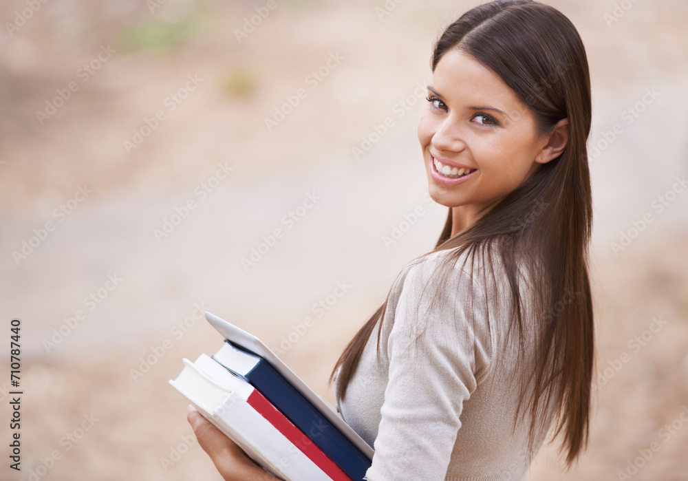 Fototapeta premium Student, portrait and books with tablet in nature, technology and education for learning at university. Park, young woman and face by happy connection, college and commitment with networking online