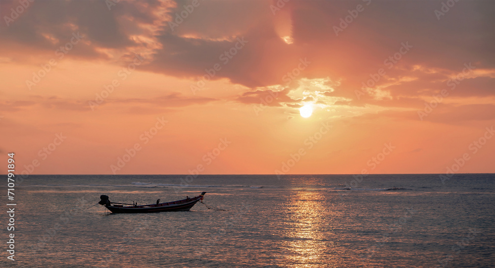 Beautiful view of sunset on the beach. Palm and boats in a sunlight.