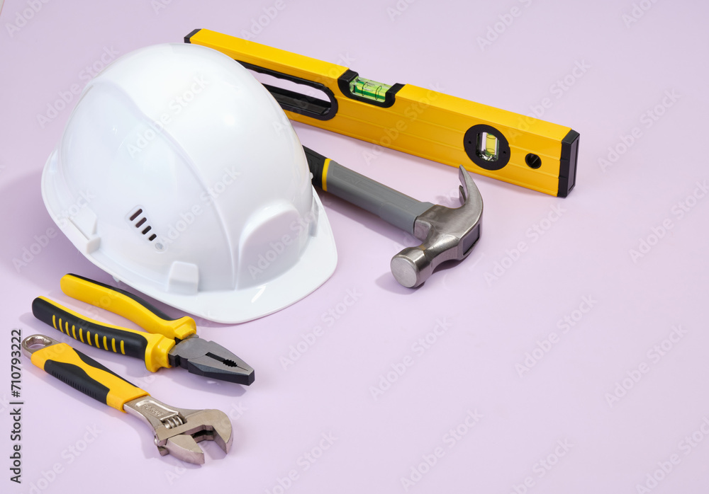 Different construction tools. Building level, plier, hammer and white head protection helmet. DIY construction tools.