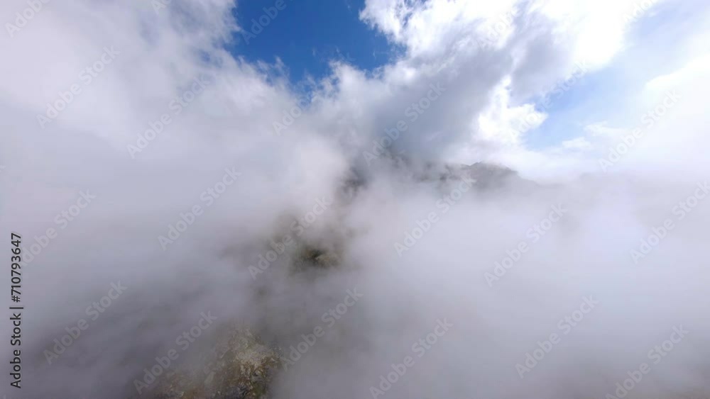 Aerial Forward Scenic Shot Of Tranquil Mountains In Clouds On Sunny Day - French Alps, France Aerial Forward Scenic Shot Of Tranquil Mountains In Clouds On Sunny Day - French Alps, France