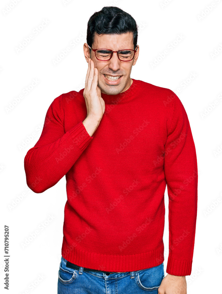 Handsome hispanic man wearing casual clothes and glasses touching mouth with hand with painful expression because of toothache or dental illness on teeth. dentist Handsome hispanic man wearing casual clothes and glasses touching mouth with hand with painful expression because of toothache or dental illness on teeth. dentist