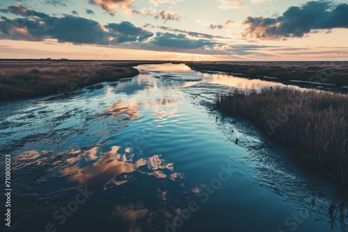 A peaceful river delta at dawn with neon sky blue veins in the water and marshes,