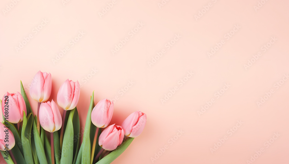 Bouquet of pink tulip flowers placed on greeting card with copy space for wish text on peach fuzz colored background